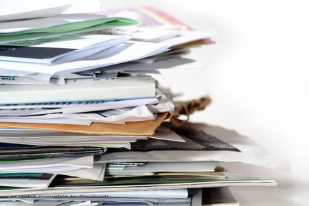 A pile of paper work that needs to be filed.