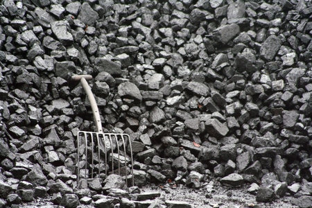 A stack of coal with a fork to the left.の写真素材