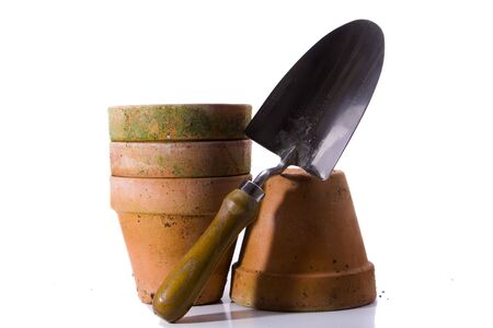 Four terracota pots and a hand spade.の写真素材