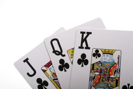 Three playing cards on a white background. 