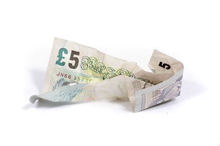 A five British pound note on a white background. の写真素材