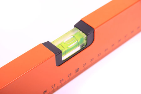 Close-up of a spirit level with the level bubble in the middle. 