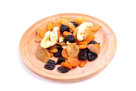 Dried fruit mix on a wooden plate. の写真素材