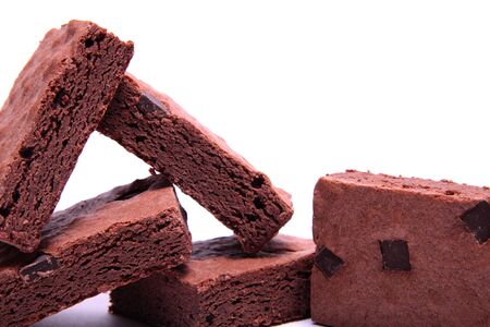 Stack of freshly made chocolate brownies on a white background. の写真素材