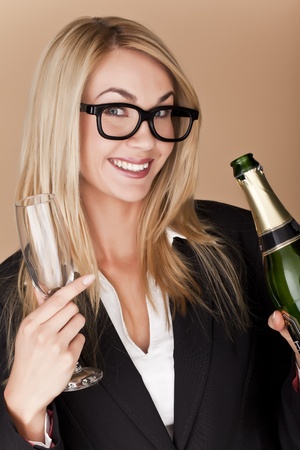 A businesswomen woman holding a glass of champagne at a party の写真素材