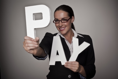 A income concept image of a woman holding letters that spell out the word pay demonstrating fare pay for woman A income concept image of a woman holding letters that spell out the word pay demonstrating fare pay for woman