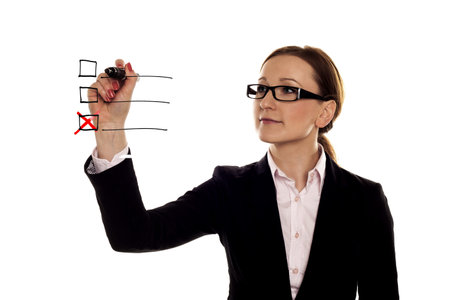 A businesswoman making a red cross on a three point checklist  
