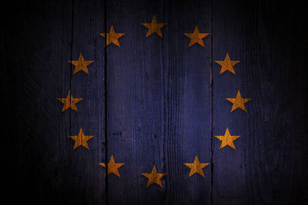 European union flag over a grunge wooden background の写真素材