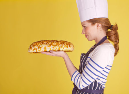 Beautiful chef over a yellow background.