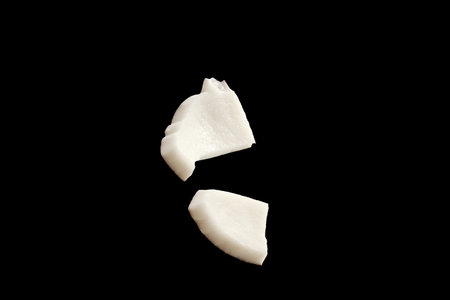 Pieces of coconut isolated on black background
