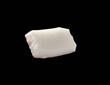 Close up view of coconut piece isolated on black backgroundの写真素材