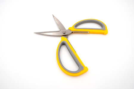 Yellow grey handle scissors isolate on white background. Paper, art, multipurpose cutting.