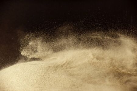 abstract powder splatted background, Freeze motion of earth dust exploding textureの写真素材