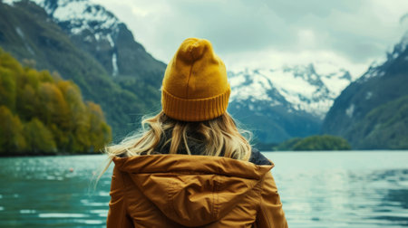 Woman Admiring Mountain Lake View in Autumnの素材