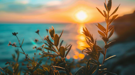A vibrant sunset over the ocean, with coastal vegetation in the foreground, capturing the peaceful beauty of a seaside evening.の素材