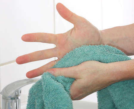 Drying hands using a towelの写真素材