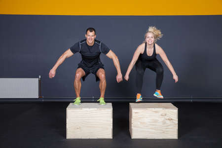 Man and woman jumping on a box - cross fitの写真素材