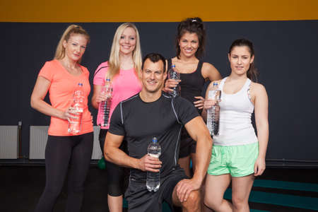 Fitness Group having a bottle of water and smiling to the cameraの写真素材
