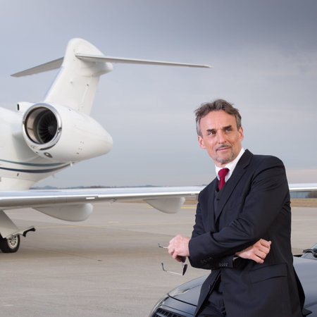 executive business man in front of corporate jet