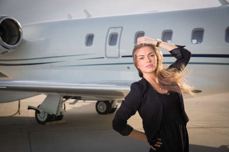 woman in front of a corporate jetの写真素材