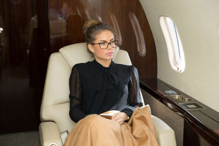 woman in corporate jet relaxingの写真素材