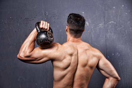 Man holding a kettlebell doing a fitness workout