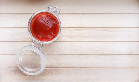 bowl with ketchup on wooden backgroundの写真素材