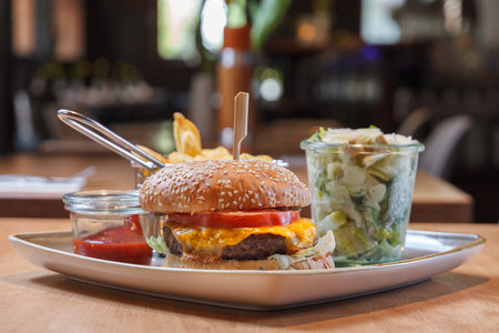 Hamburger with frech fries and caesars salad