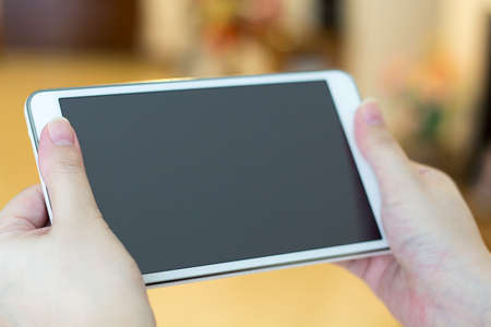 Hands holding White phoneの写真素材