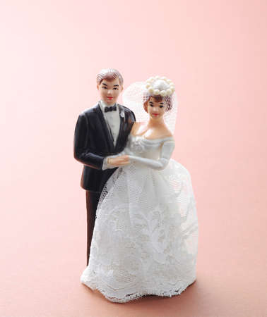 wedding couple doll on pink backgroundの写真素材