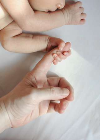 new born baby holding father s hand