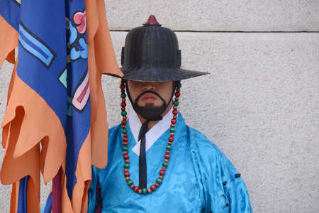 SEOUL, KOREA - OCTOBER 22 : Korean guard dressed in a blue uniform and holding a lance stands at the entrance to the Gyeongbokgung Palace in Seoul, Korea on October 22, 2014.のeditorial素材