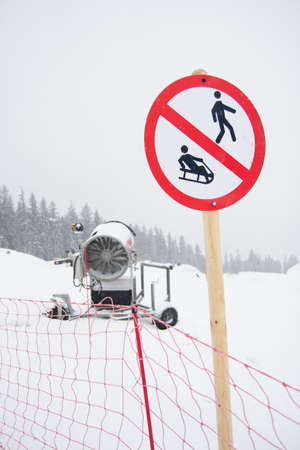 A snow cannon being used to cover a mountain - snowmakingの写真素材