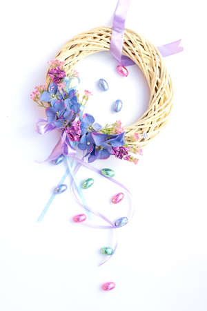 Beautiful pastel Easter Easter wreath with chocolate eggsの写真素材