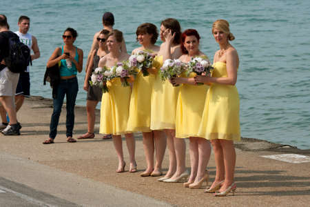 CHICAGO, IL - MAY 26:  An unidentified group of five bridesmaids gets ready for a wedding photo shoot while standing at the edge of Lake Michigan off Lakeshore Drive.  The wedding took place over the long Memorial Day Holiday weekend, and the photo had toのeditorial素材