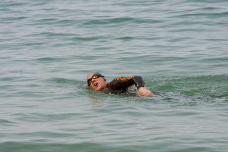 CHICAGO, IL - MAY 26:  A male swimmmer works out by swimming freestyle stroke in Lake Michigan over the Memorial Day holiday weekend. This scene is just off the shoreline that runs along Chicago's famous Lake Shore Drive.  Thousands of people came outdoorのeditorial素材