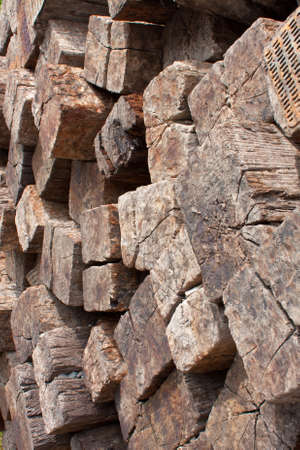 Wood texture of large stack of railroad ties piled high next to railroad tracks.のeditorial素材