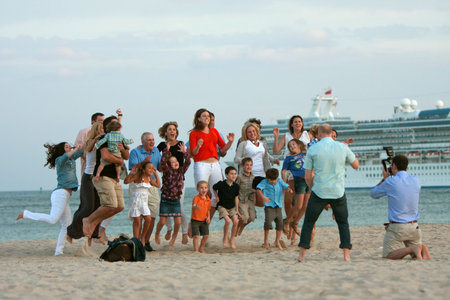 Ft. Lauderdale, FL, USA - December 29, 2012:  An unidentified family jumps in the air while posing for a staged photo on the beach of a Ft. Lauderdale resort, over the Christmas holidays.のeditorial素材