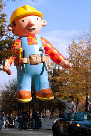 Atlanta, GA, USA - December 1, 2012:  A huge inflated construction worker balloon moves through the parde route at the annual Atlanta Christmas parade in downtown Atlanta.のeditorial素材