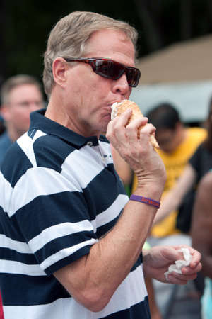 Atlanta, GA, USA - July 27, 2013:  An unidentified man licks a waffle ice cream cone at the 3rd Annual Atlanta Ice Cream Festival at Piedmont Park.  The event was free and open to the public.のeditorial素材