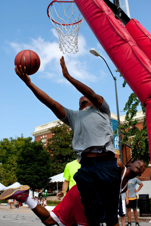 Athens, GA, USA - August 24, 2013:  A young man shoots a reverse layup in a 3-on-3 basketball...