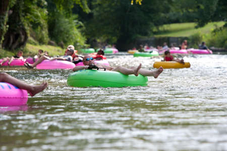 Helen, GA, USA - August 24, 2013:  Dozens of people enjoy tubing down the Chattahoochee River in North Georgia on a warm summer afternoon.のeditorial素材