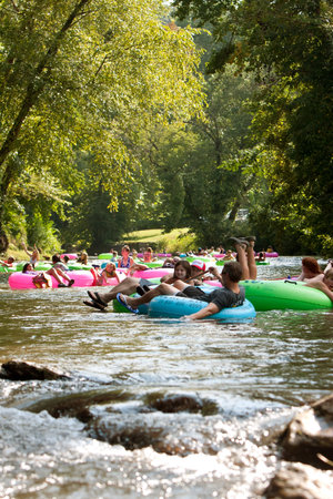 Helen, GA, USA - August 24, 2013:  Dozens of people relax while tubing down the Chattahoochee River in North Georgia on a warm summer afternoon.のeditorial素材