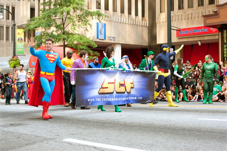 Atlanta, GA, USA - August 31, 2013:  Superman character carries banner while walking down Peachtree...