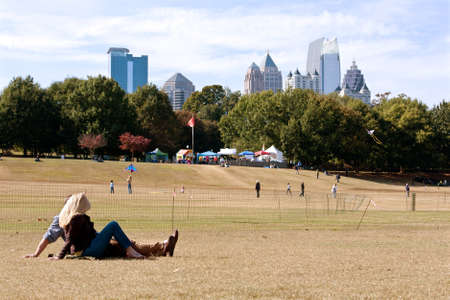 Atlanta, GA, USA - October 26, 2013:  A young couple lays on the grass and watches people fly kites at the World Kite Festival in Piedmont Park.のeditorial素材