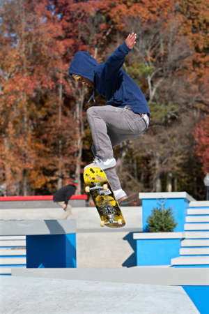 Kennesaw, GA, USA - November 24, 2013:  A young adult skateboarder catches air performing a jump while taking part in the grand opening weekend of the new Kennesaw Skateboard Park.のeditorial素材