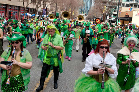 Atlanta, GA, USA - March 15, 2014   A band dressed in eclectic green costumes plays while marching in the St  Patrick s paradeのeditorial素材
