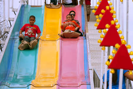 Atlanta, GA, USA - March 15, 2014:  A family slides down the fun slide at the annual Atlanta Fair.のeditorial素材