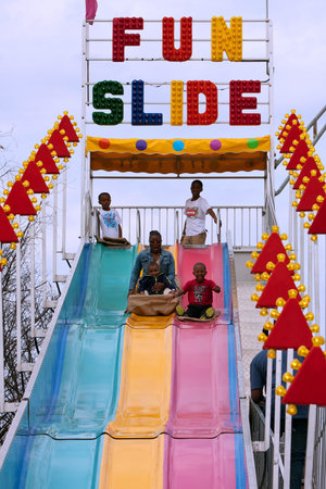 Atlanta, GA, USA - March 15, 2014:  A family slides down the fun slide at the annual Atlanta Fair.のeditorial素材