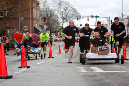 Lawrenceville, GA, USA - March 29, 2014:  Two teams race custom designed beds through downtown Lawrenceville, to benefit a local homeless shelter. のeditorial素材